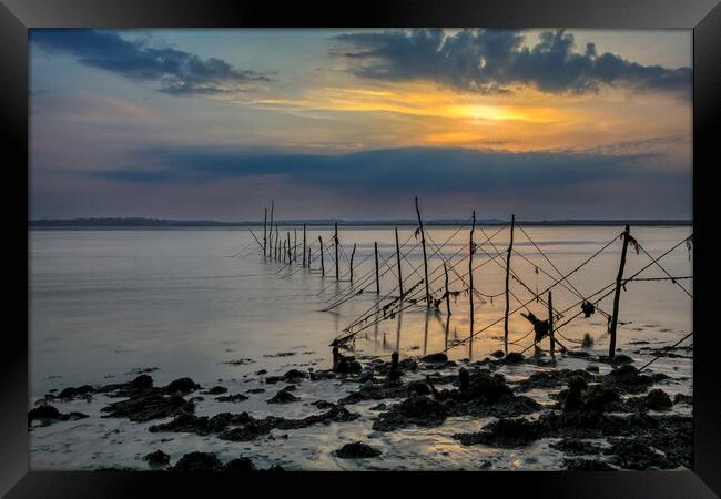 Fishing nets at Sunset Framed Print by Derek Beattie