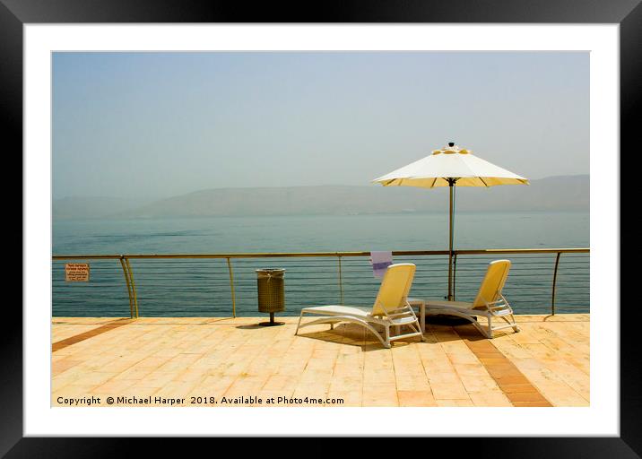 Sun beds and Brolly on the shores of Galilee Framed Mounted Print by Michael Harper