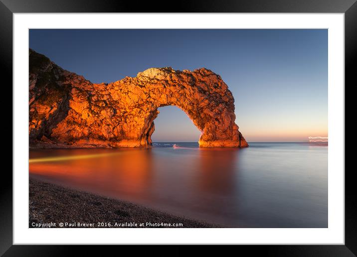 Durdle Door Dorset with an illuminated Canoeist   Framed Mounted Print by Paul Brewer