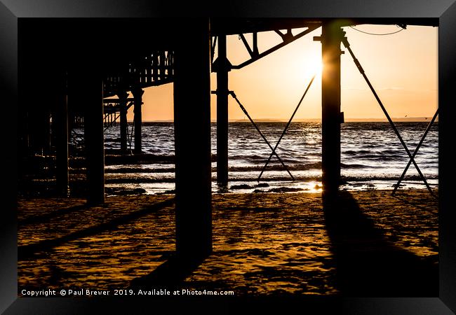Sunset underneath Weston Super Mare Pier Framed Print by Paul Brewer
