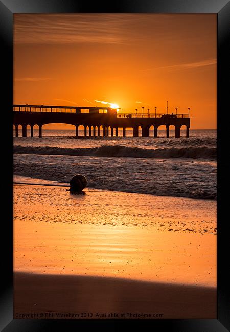 Sunrise over the pier Framed Print by Phil Wareham