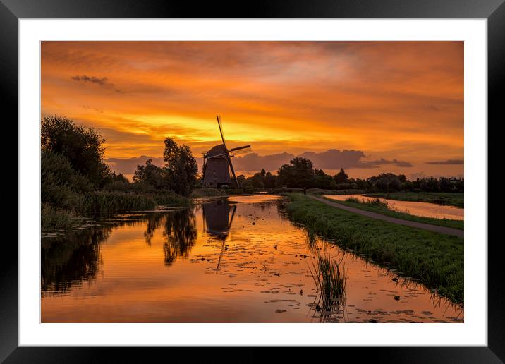 Windmill at the warm and red color sunrise in Haze Framed Mounted Print by Ankor Light
