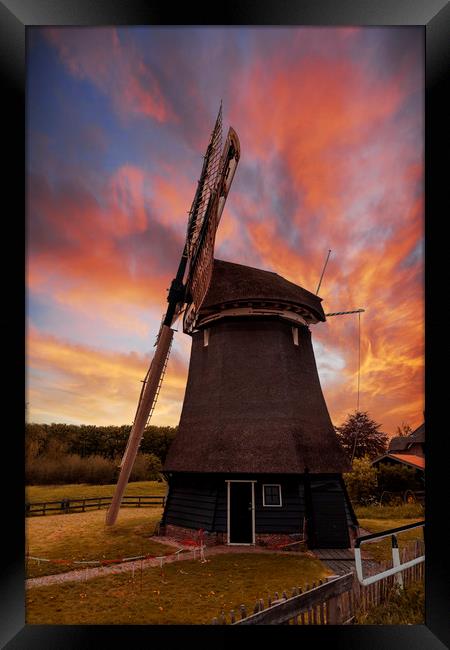 Vivid red and orange color sunset over a Dutch win Framed Print by Ankor Light