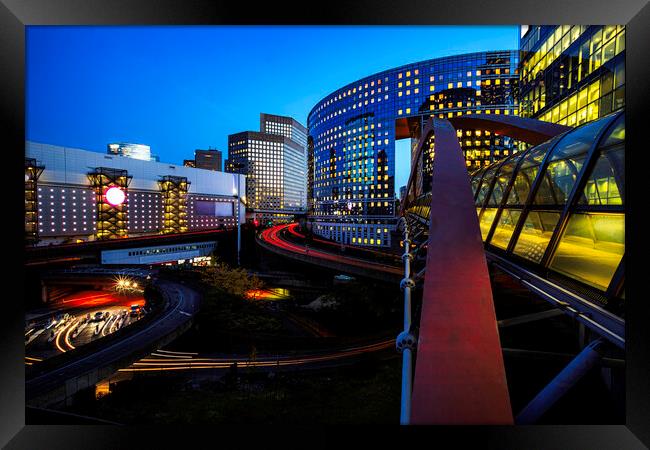 A view of a city at night Framed Print by Ankor Light