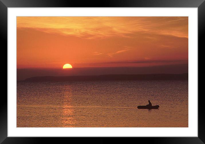A lone boatman returns to shore Framed Mounted Print by Simon Armstrong