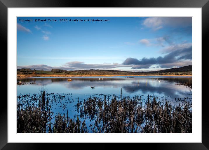 Winter view across the lake towards the reed beds Framed Mounted Print by Derek Corner