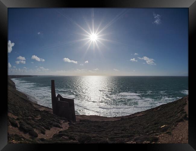 Sun shining over Wheal Coates ruins coast path Framed Print by mark humpage