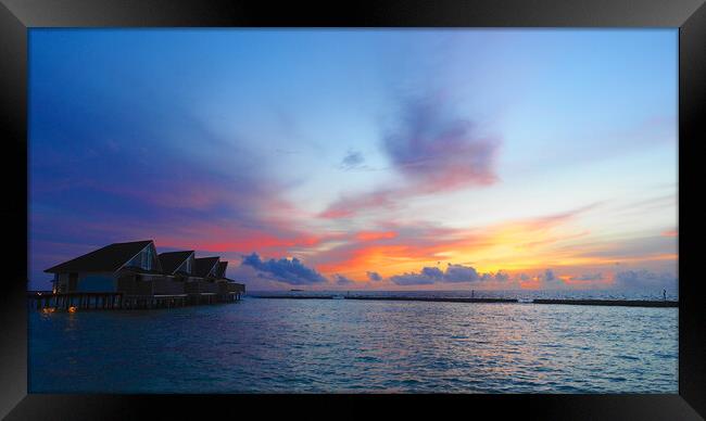 Sunset sea view over Maldives water bungalows  Framed Print by mark humpage