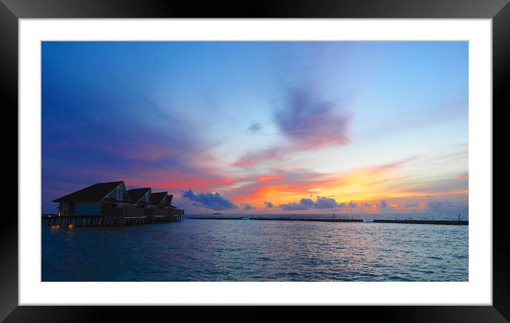 Sunset sea view over Maldives water bungalows  Framed Mounted Print by mark humpage