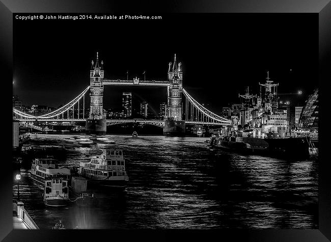 London's Iconic Bridge and Warship Framed Print by John Hastings