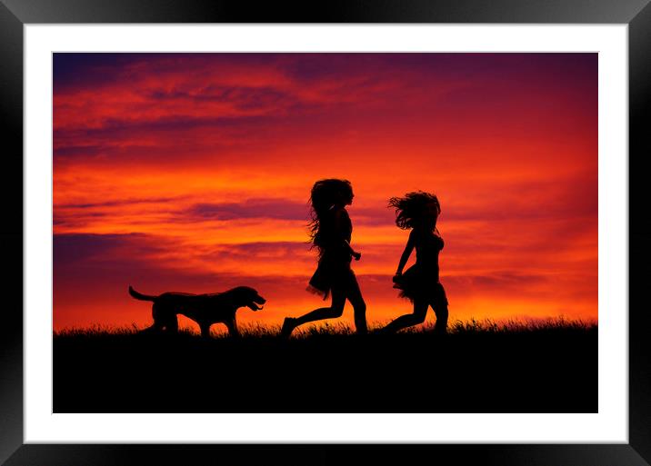 Two Girls and their dog running at sunset Framed Mounted Print by Maggie McCall