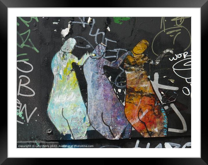 Graffiti depicting three figures standing next to each other. Framed Mounted Print by Luigi Petro