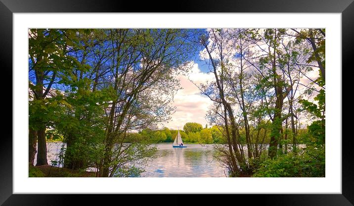 Small sailing boat on the lake between some tree's Framed Mounted Print by Sue Bottomley