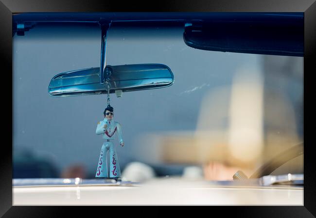 Elvis figure hangs fom rear view mirror Framed Print by Phil Crean