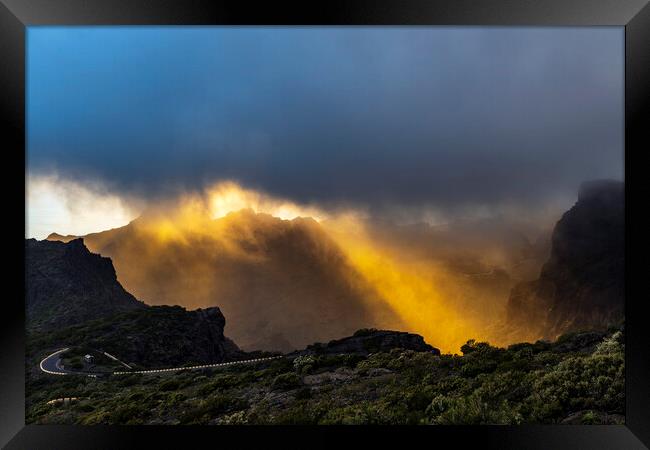 Golden rays of sunshine through the rainclouds Framed Print by Phil Crean