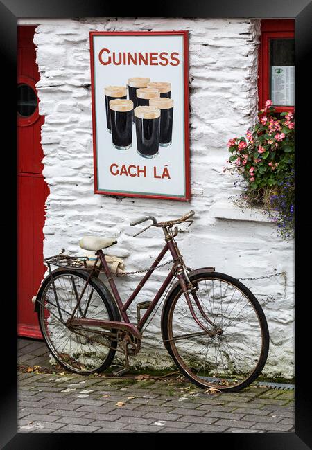 Old Guinness ad and Bicycle, West Cork, Ireland Framed Print by Phil Crean