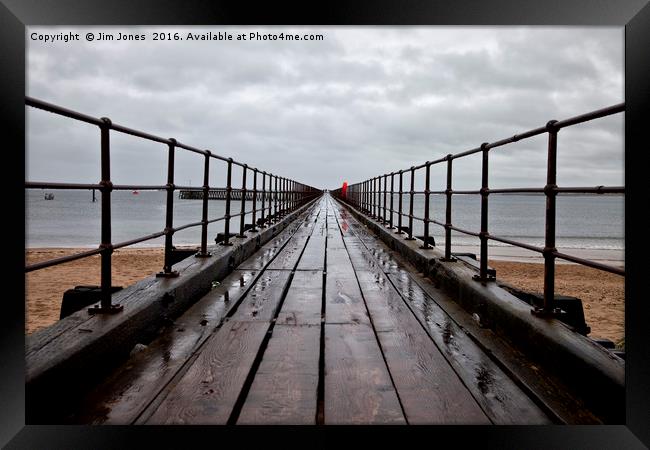 Wet wooden pier Framed Print by Jim Jones