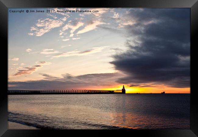Sunrise over the piers Framed Print by Jim Jones