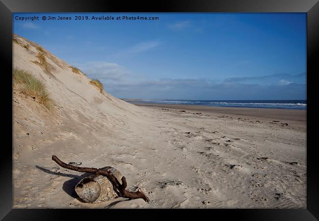 Driftwood on the beach at Druridge Bay Framed Print by Jim Jones