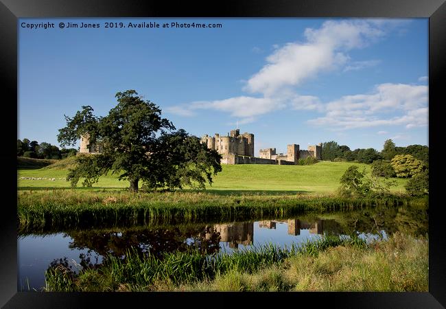 Alnwick Castle reflected in the River Aln Framed Print by Jim Jones