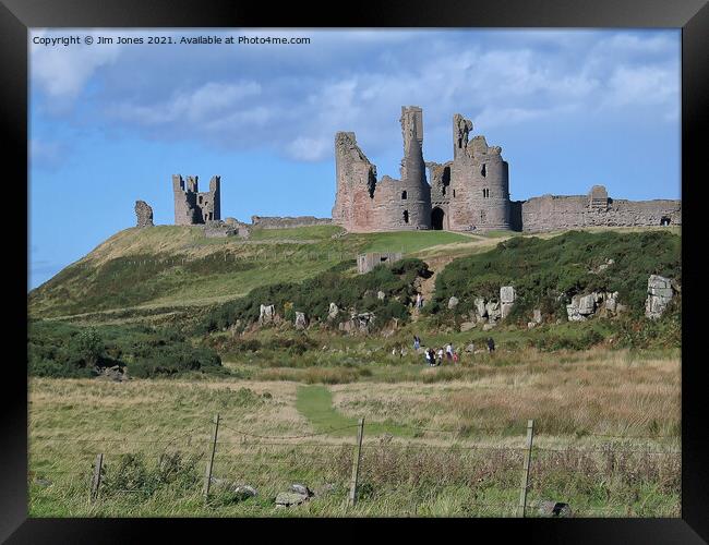 Majestic Ruins of Dunstanburgh Castle in Northumbe Framed Print by Jim Jones