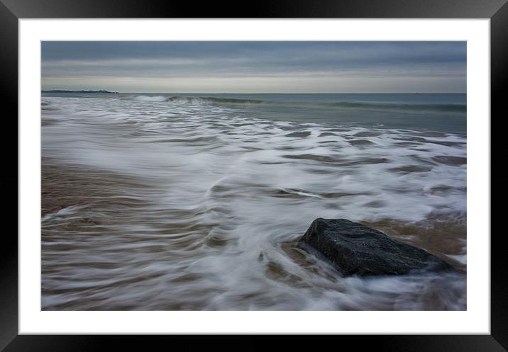 Ebb tide and a rock Framed Mounted Print by Ian Jones