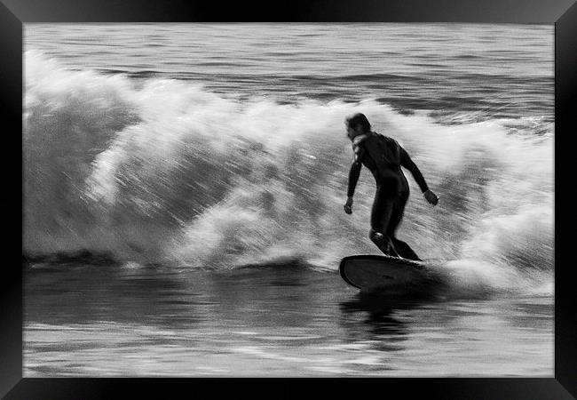 Surfer on a wave Framed Print by Ian Jones