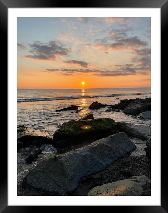A rocky beach next to a body of water Framed Mounted Print by Victoria Bowie