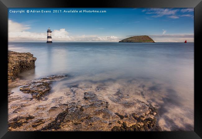 Puffin Island Lighthouse Anglesey Framed Print by Adrian Evans