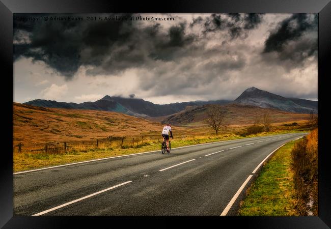 Cyclist Snowdonia Winter  Framed Print by Adrian Evans