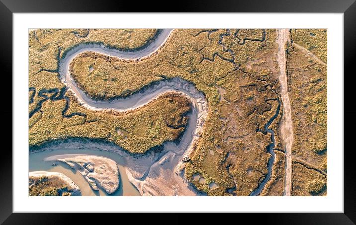 A lone rowing boat on the meandering creeks of Burnham Deepdale Framed Mounted Print by Gary Pearson
