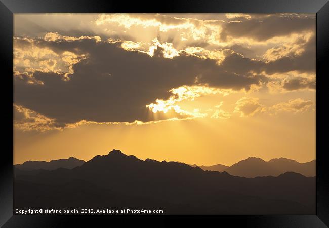 Sunlight through clouds Framed Print by stefano baldini