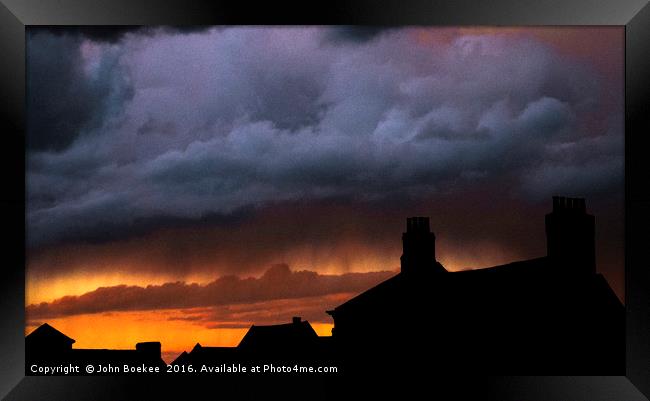 Storm over Norwich with sunset Framed Print by John Boekee