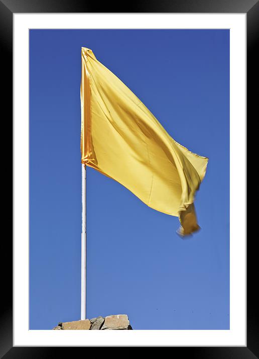 Yellow flag fluttering in blue sky Framed Mounted Print by Arfabita  