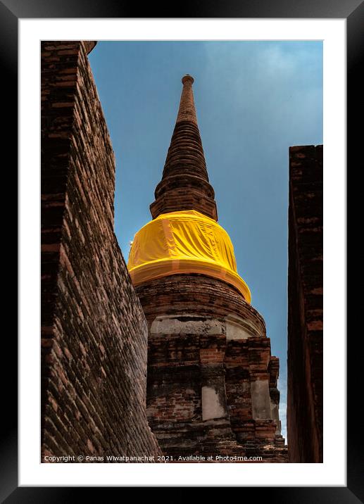 An ancient pagoda behind a brick building Framed Mounted Print by Panas Wiwatpanachat