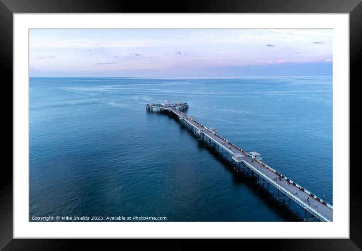 Pier in calm waters Framed Mounted Print by Mike Shields