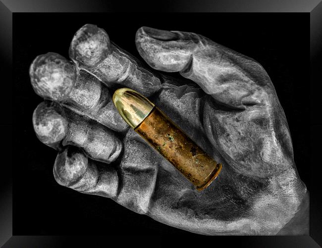 Bullet in hand Framed Print by Jonathan Thirkell