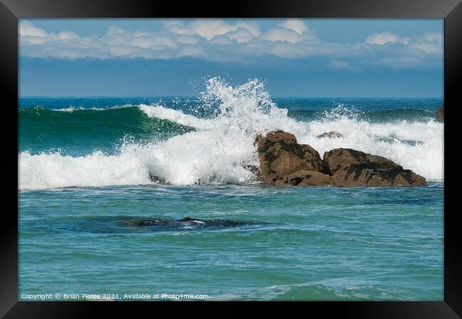 Waves rolling onto a rocky Cornish Beach Framed Print by Brian Pierce