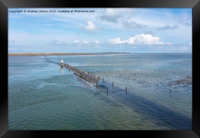 holy island causeway near high tide Framed Print by Graham Moore