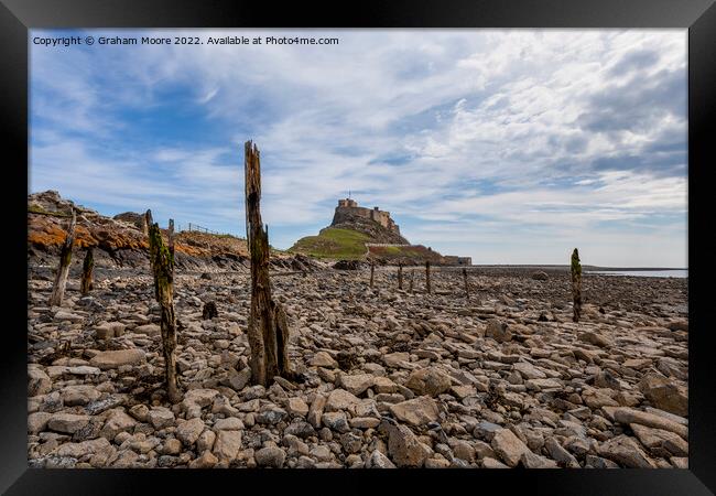 lindisfarne castle from the rocky shore Framed Print by Graham Moore