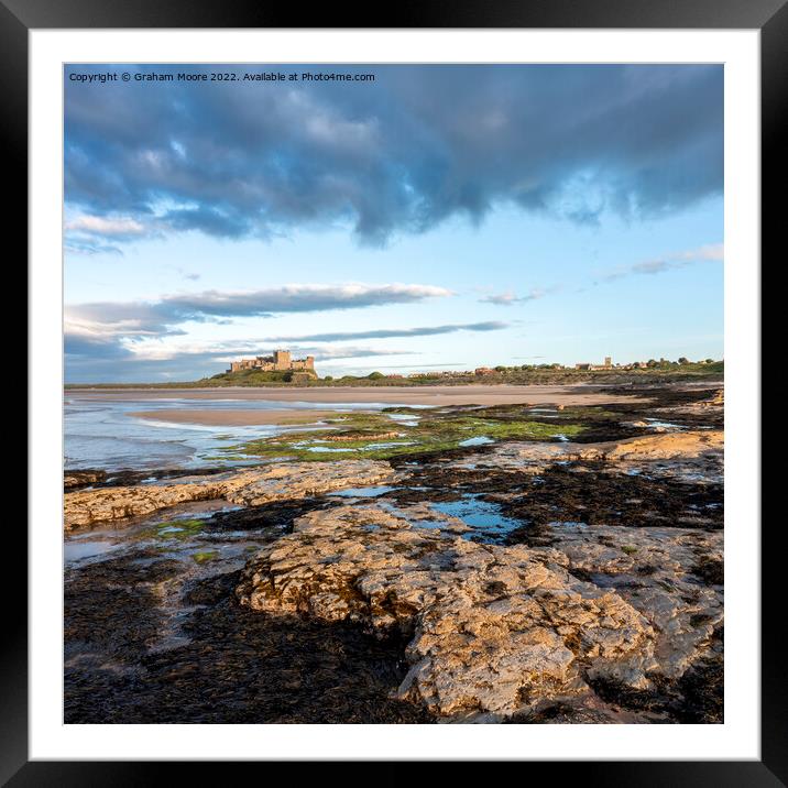 Bamburgh Castle from Harkness Rocks sunset elevated Framed Mounted Print by Graham Moore