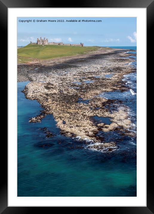 Dunstanburgh Castle from the sea elevated Framed Mounted Print by Graham Moore