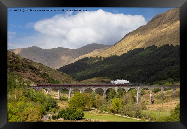 Steam train crossing Glenfinnan viaduct Framed Print by Graham Moore