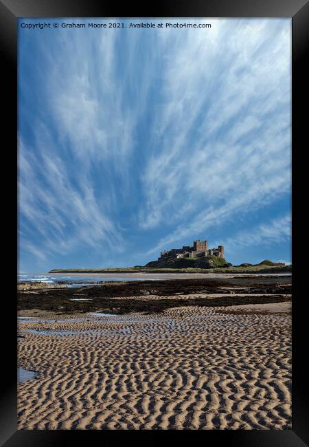 Bamburgh Castle with streaky clouds Framed Print by Graham Moore