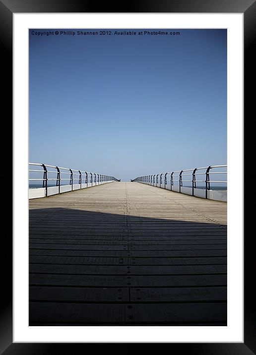 Looking down the pier Framed Mounted Print by Phillip Shannon