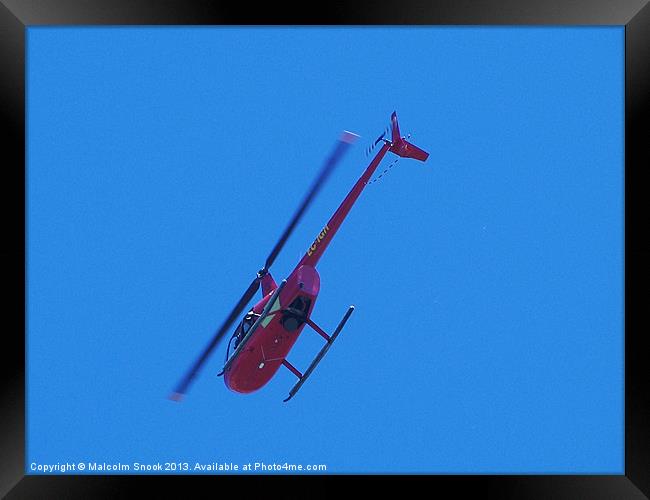 Red R44 helicopter from below Framed Print by Malcolm Snook