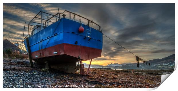 Sunrise colour beyond a beached vessel. Print by Richard Smith