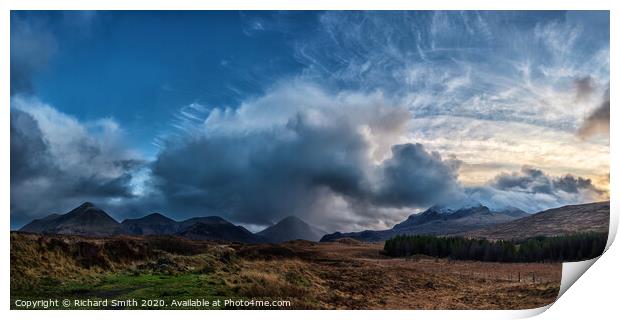 The sun setting to the right of a panorama of the red and black Cuillin Hills. Print by Richard Smith