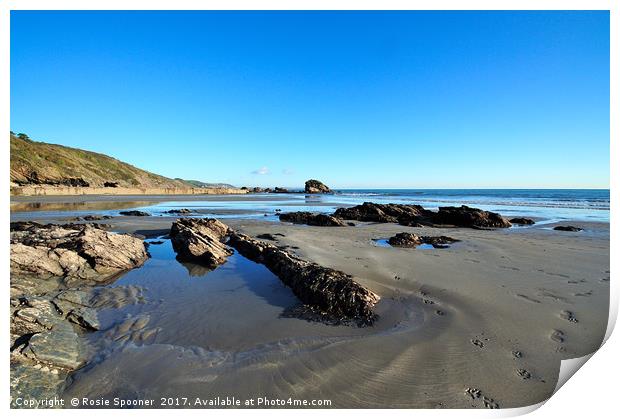 Millendreath Beach and Black Rock at low tide Print by Rosie Spooner