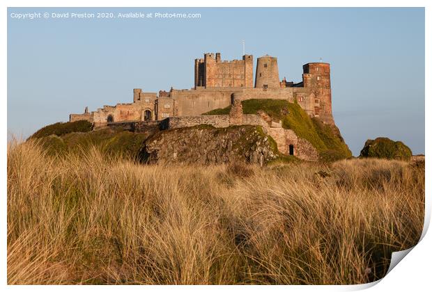 Bamburgh castle at sunset Print by David Preston